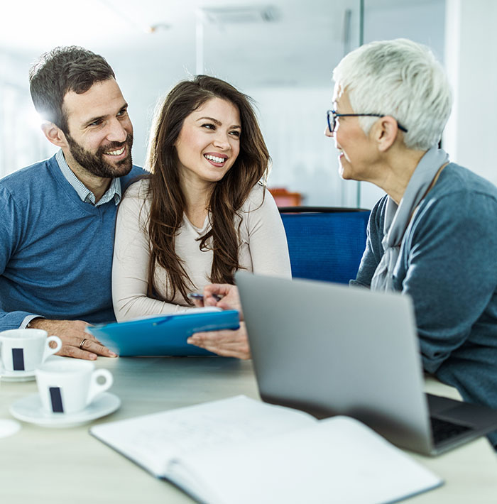 three people listening and taking notes